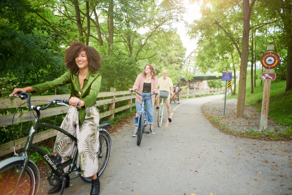 a group of people riding bicycles on a path