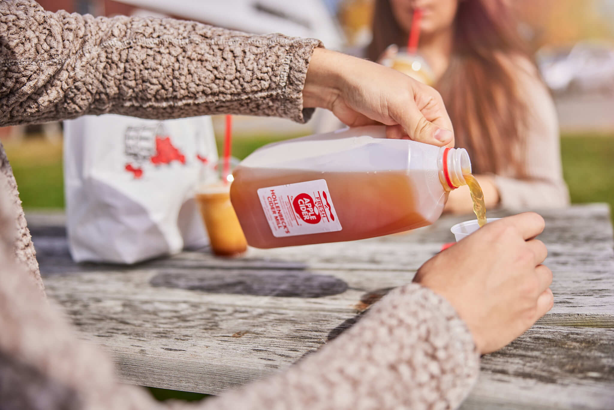 Pouring cider into a cup