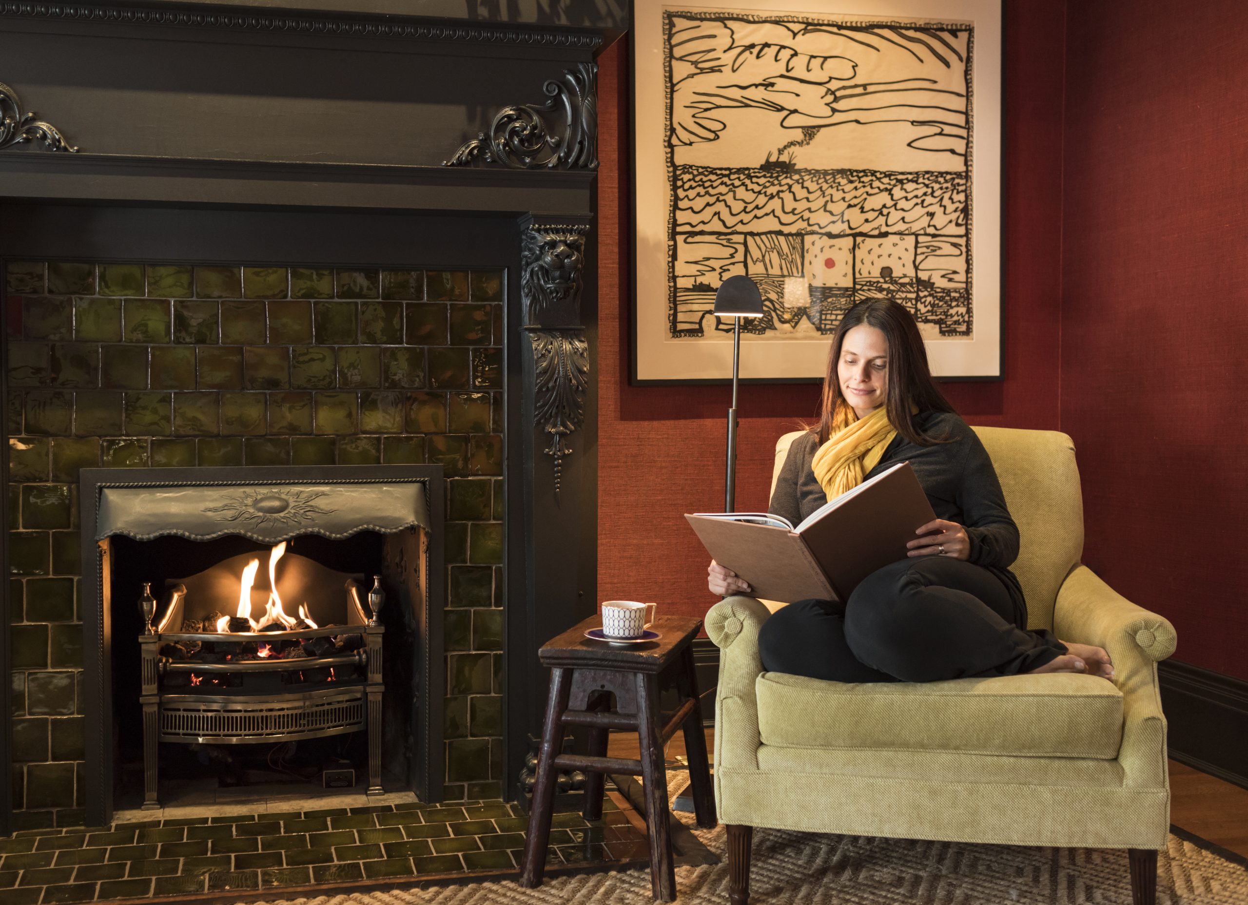 Cozy reading nook by the fireplace in Rowland House
