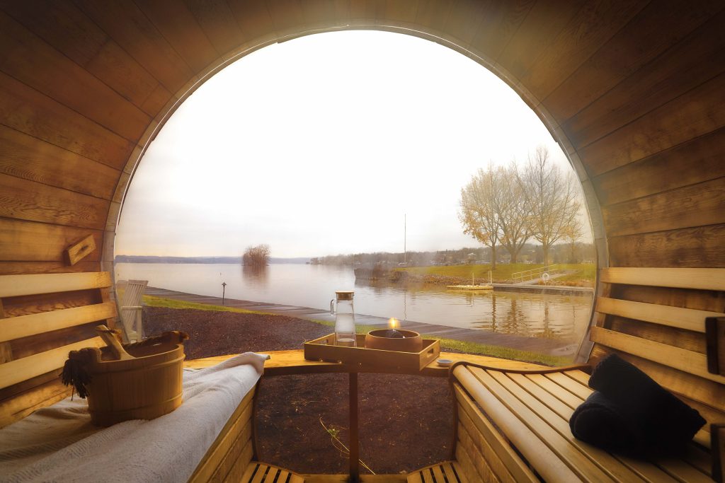 Serene lakeside spa view with seating.