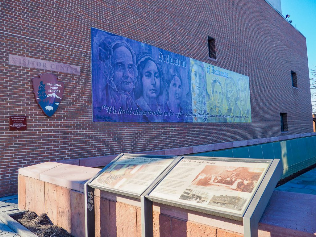 Women’s rights mural and visitor signs at Women’s Rights National Historical Park in Seneca Falls, NY